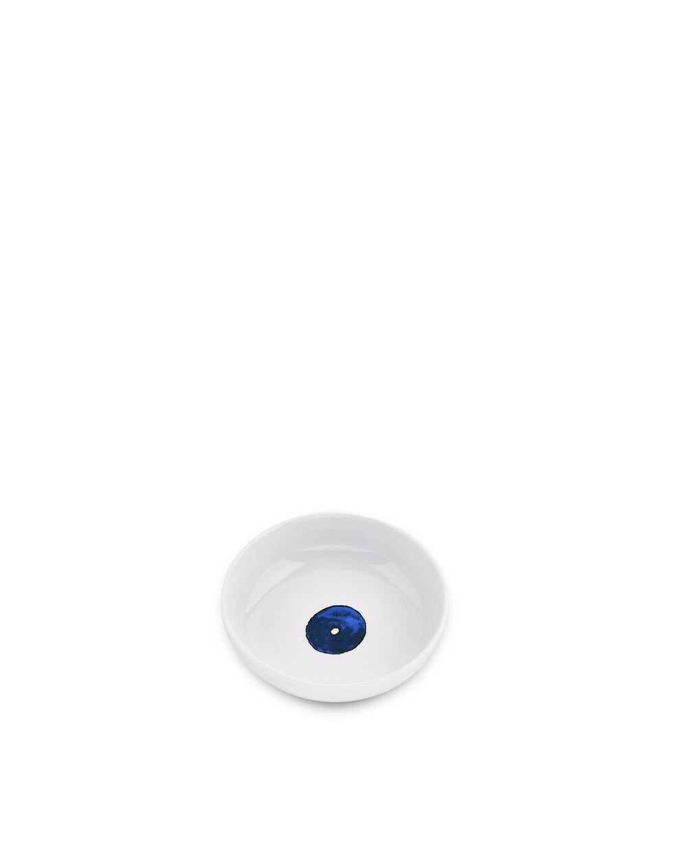 White ceramic pet bowl by Alessi with a dark blue eye design in the center.