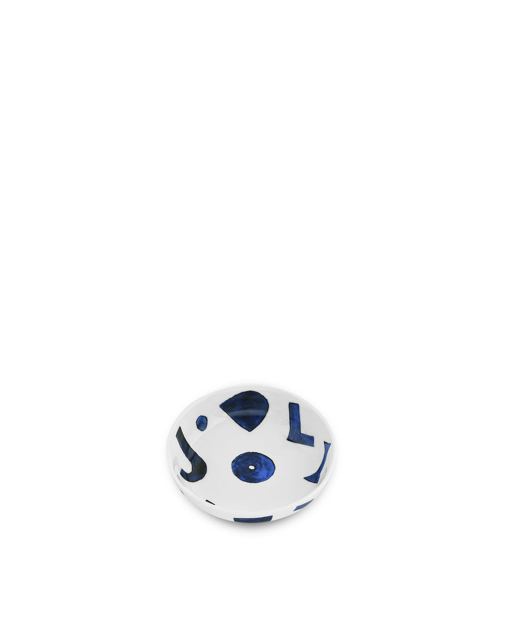 White ceramic cat bowl by Alessi, decorated with blue abstract shapes, seen from an overhead angle.