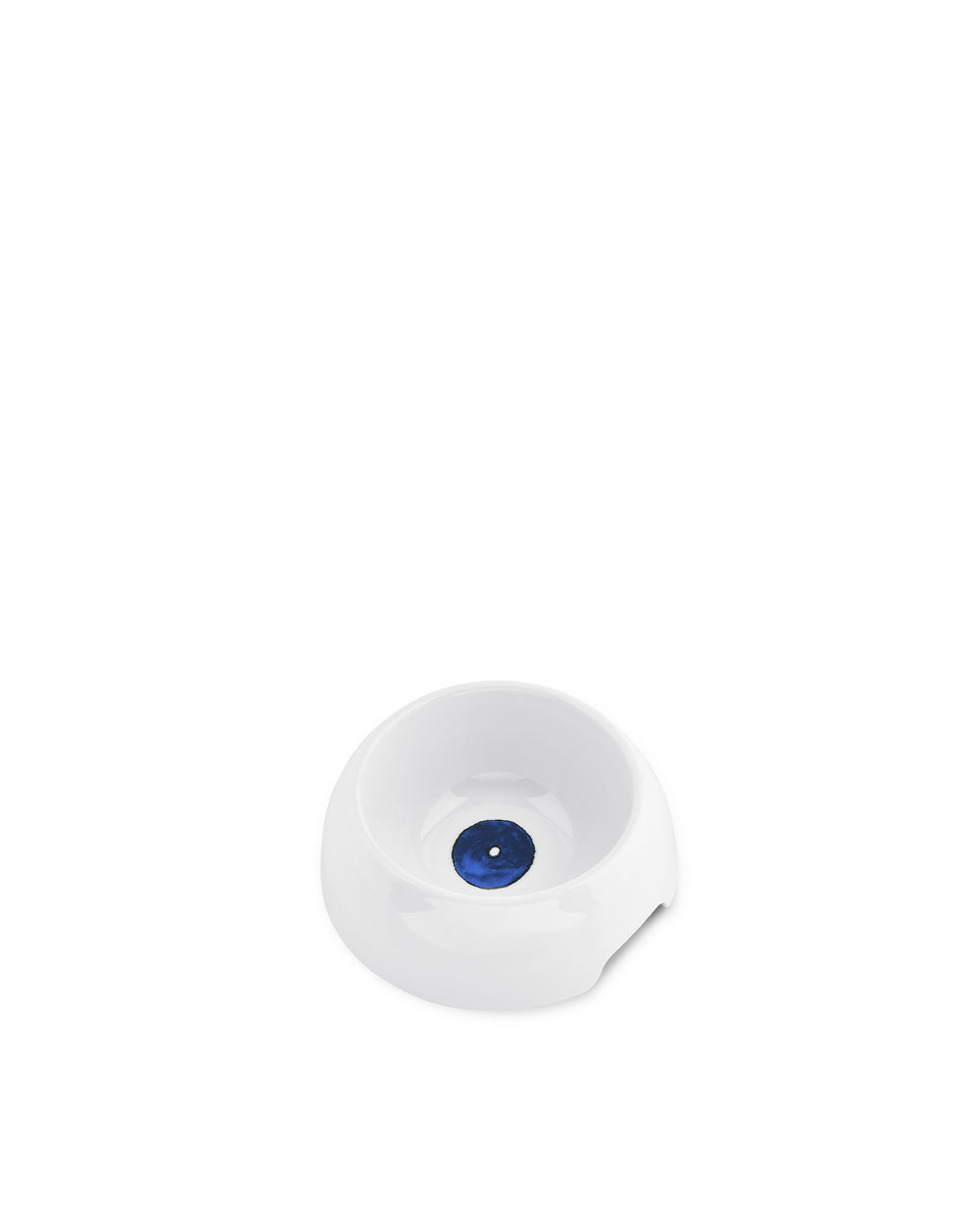 White ceramic dog bowl by Alessi, featuring a deep blue eye-like circle at its base.