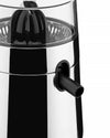 Black and chrome electric citrus juicer by Alessi, with a transparent lid, black reamer, and juice spout.