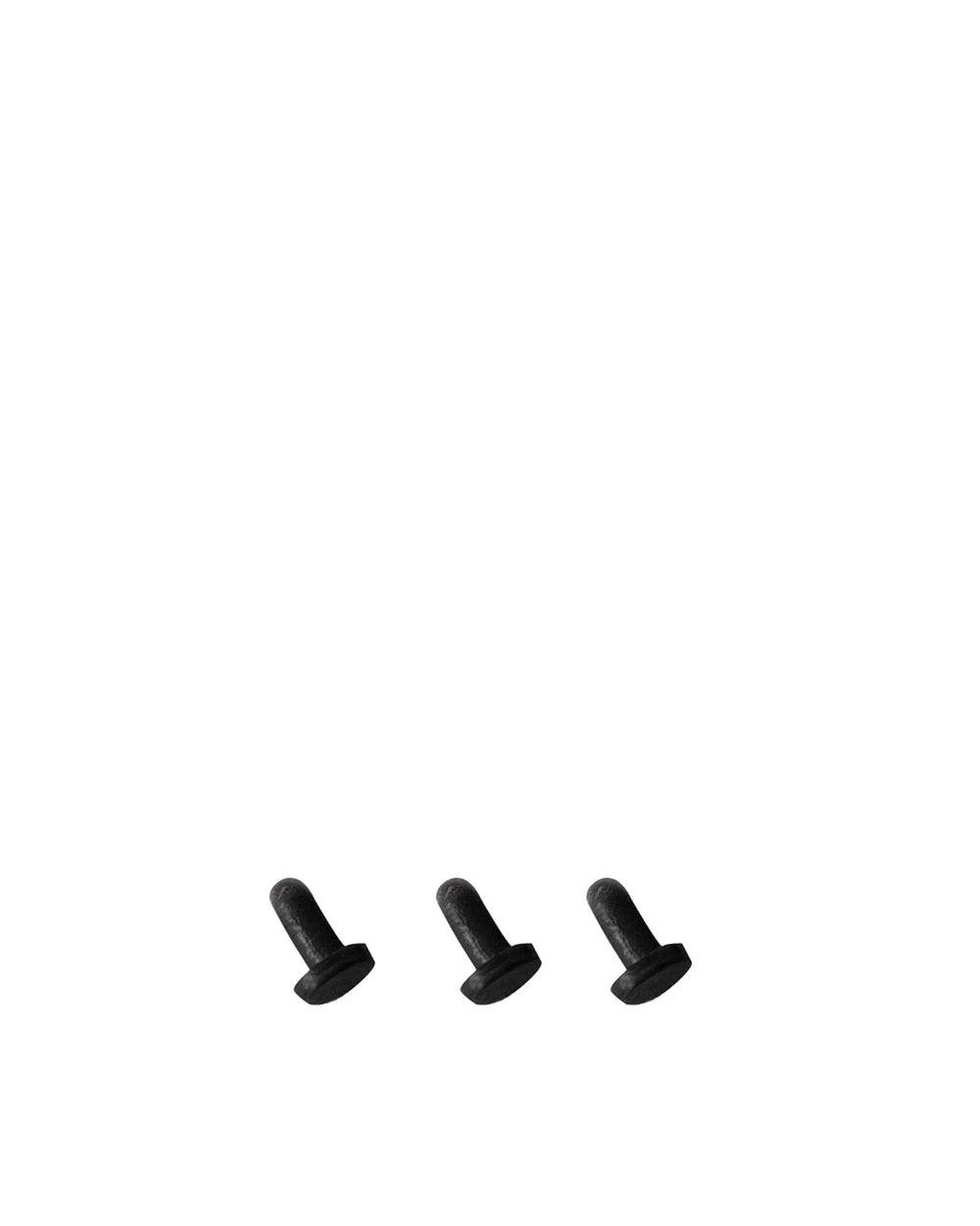 Three black cylindrical spare parts by Alessi with flat bases and matte texture.