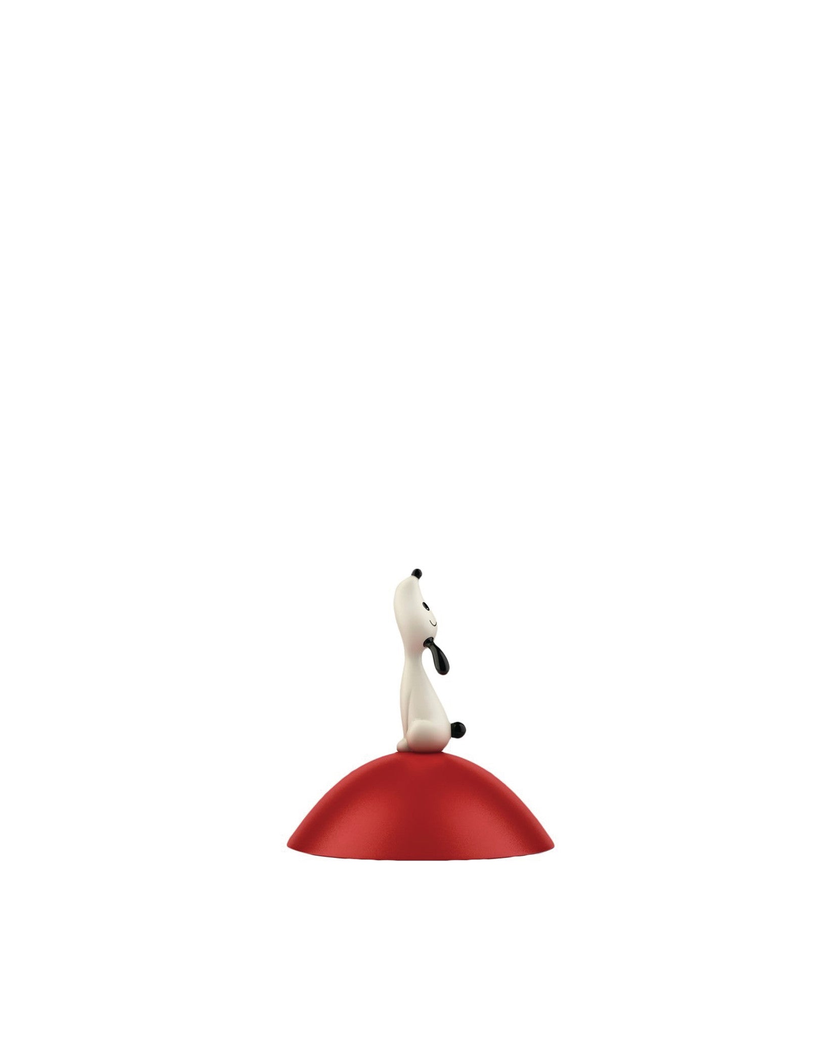Spare part by Alessi, a white dog figure with black details sitting on a glossy red dome.