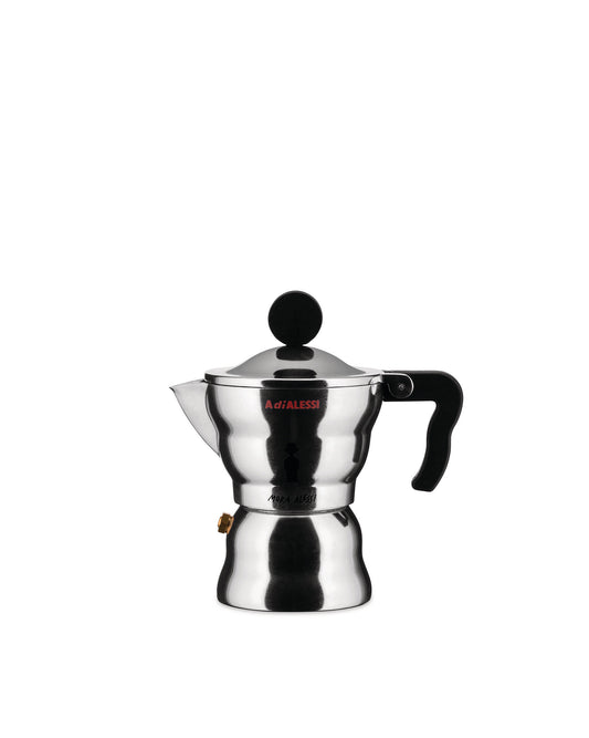 Eine Moka-Kaffeekanne von Designer Alessandro Mendini. Die aus Aluminium gefertigte Mokakanne mit schwarzem Kunststoffgriff und -knauf ist eine Anspielung auf die traditionelle Espressokanne, jedoch mit einer verspielten, runden und gewellten Form. Erhältlich in den Varianten für 1, 3 und 6 Tassen.